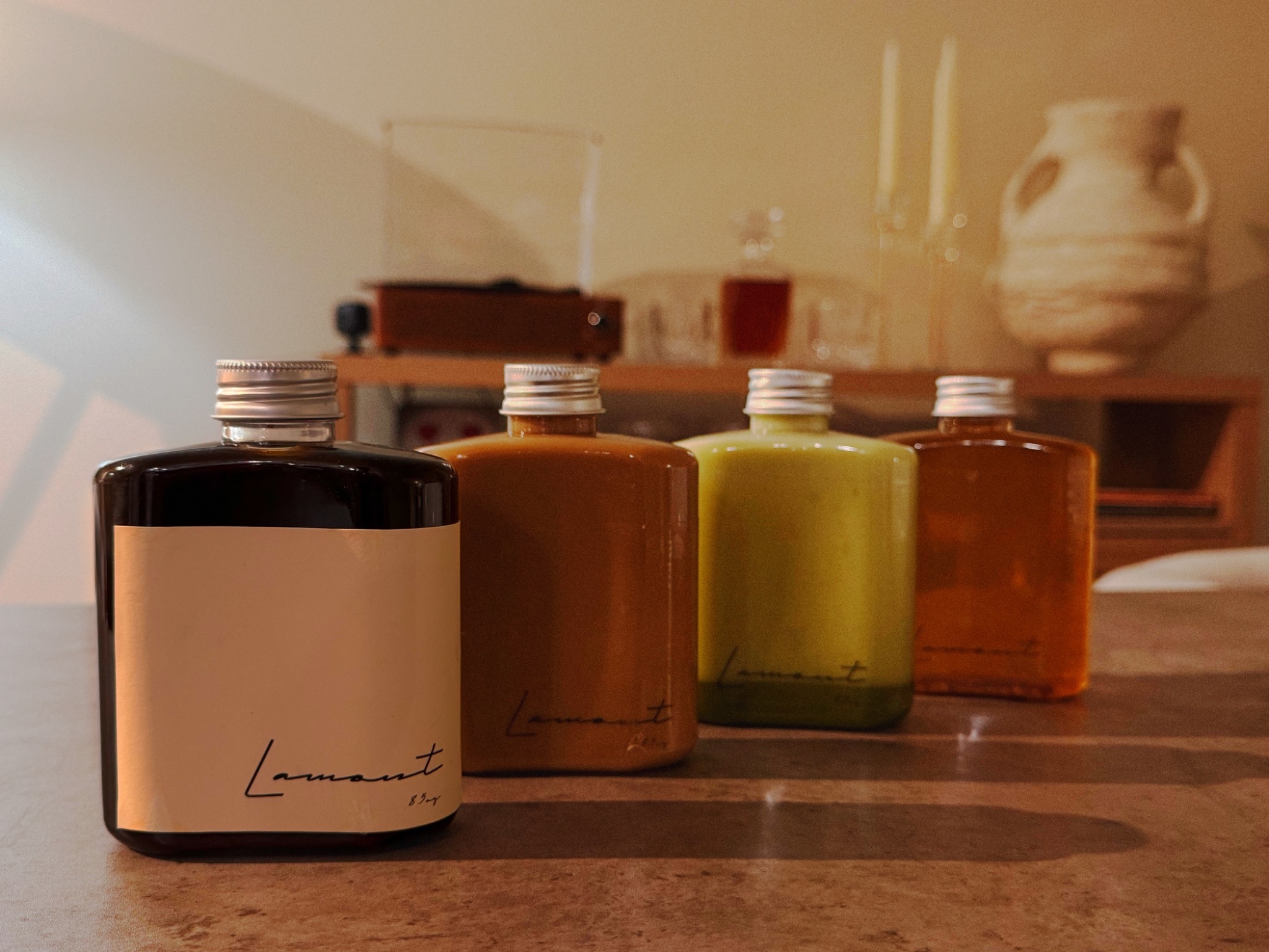 LAMONT. bottled coffee, tea, and matcha gathered on a table